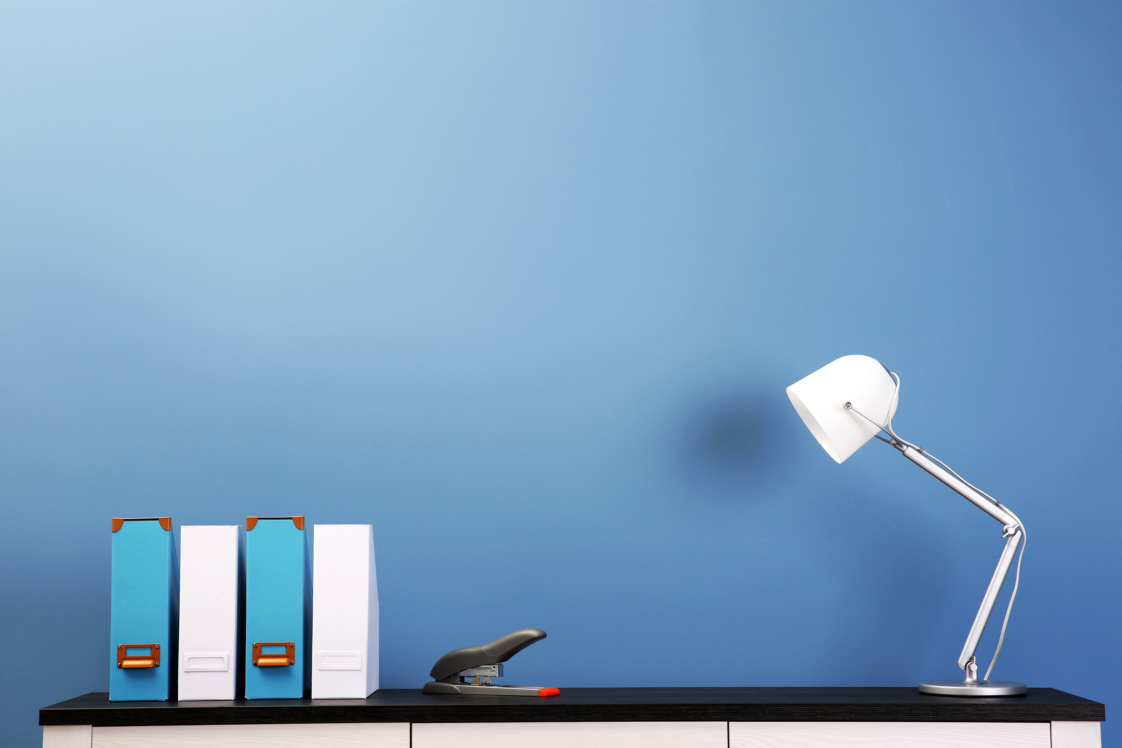 Table Lamp and Folders on an Office Cabinet 